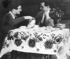 Elegant café table with a young couple enjoying tea and each other.