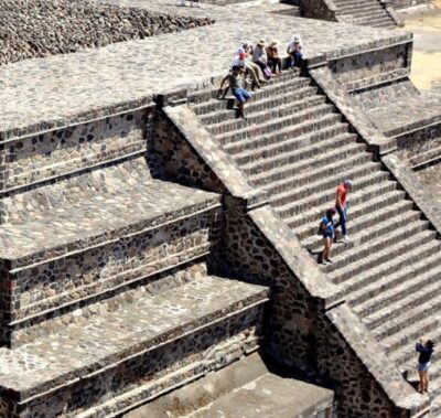 Tourists climb the very steep steps of Plaza de la Pirámide de la Luna, at Teotihuacan, Mexico.